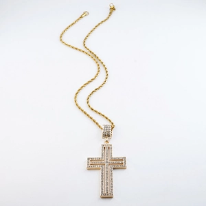 Detail of gold layered cross pendant with sparkling crystals and rope chain