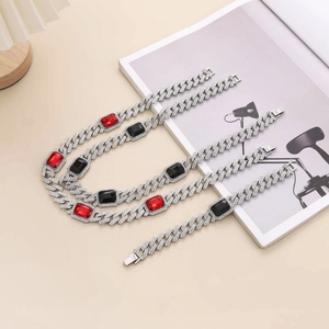 Hip-hop Cuban link chain set with ruby and black stones on a neutral background
