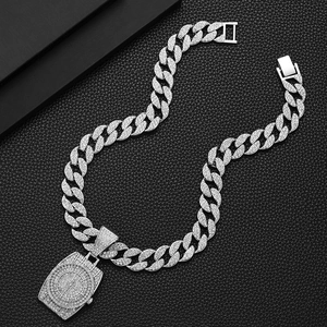 Macro shot of silver hip-hop Cuban chain necklace with a full iced-out watch pendant