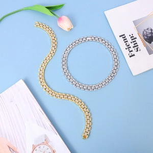 Detail view of gold and silver cuban link bracelets with full micro-paved diamond setting