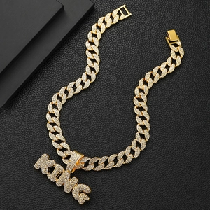 Iced out gold Cuban link necklace with sparkling KING letter pendant in hip hop style