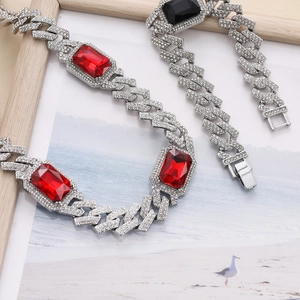 Detail of silver cuban chain set with red and black rectangle gemstones and micro pavé rhinestones