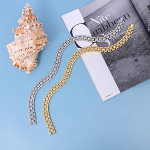 Detail of gold and silver cuban link bracelets with three-row iced out zircon stones