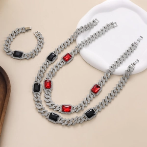 Detail view of hip hop Cuban chain set with pavé rhinestones and red black rectangular gems