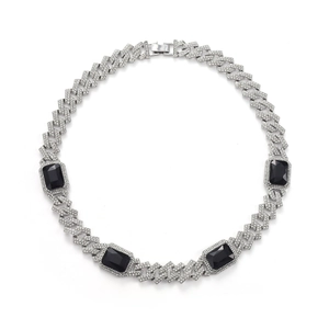 Detail of silver Cuban chain necklace with micro-paved crystals and black rectangular gemstones