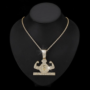 Macro shot of iced out money bag pendant with dollar sign and muscular arm detail