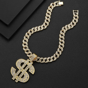 Detailed view of hip hop dollar sign pendant with iced out cuban link on black leather