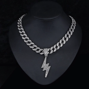 Close-up of iced out silver lightning pendant on a thick Cuban link chain necklace