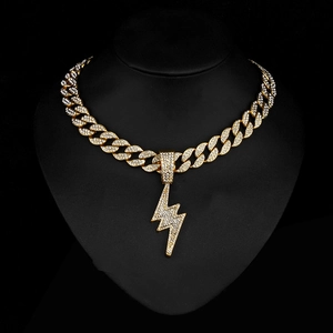 Close-up of iced out gold lightning pendant with shimmering cubic zirconia on cuban chain