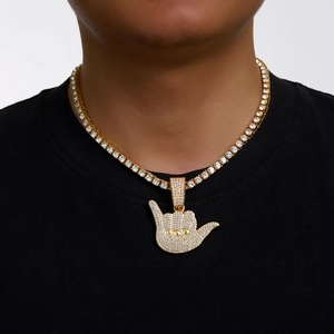 Hip hop tennis chain with gold shaka hand gesture pendant encrusted in zircon stones
