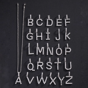 Silver iced out A-Z letter pendant set with zircon stones on black leather background