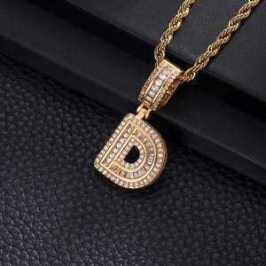 Detail of hip hop letter D pendant with gold plating and cubic zirconia on rope chain