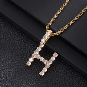 Close-up of hip hop rope chain with a gold H-letter pendant encrusted with cubic zirconia