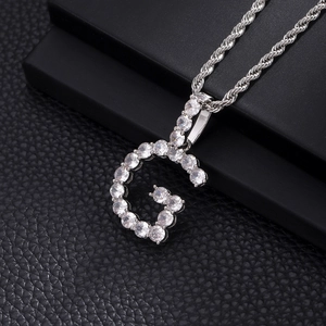 Close-up of hip hop letter G pendant with cubic zirconia and silver twist chain