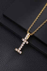 Macro view of gold plated copper letter I pendant with zircons and twist chain