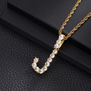 Detail of gold-plated rope chain with letter J pendant featuring paved cubic zirconia