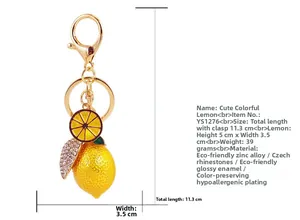 Macro detail of yellow lemon keychain with sparkling crystals and zinc alloy finish