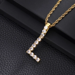 Detail of Letter L gold pendant necklace with cubic zirconia on black display stand