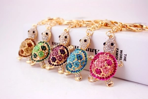 Detail showing five colorful rhinestone turtle keychains with gold-plated lobster clasps