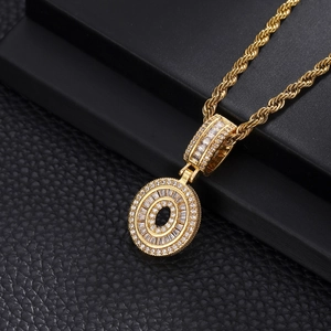 Macro detail of iced-out letter O pendant in gold plating with sparking cubic zirconia