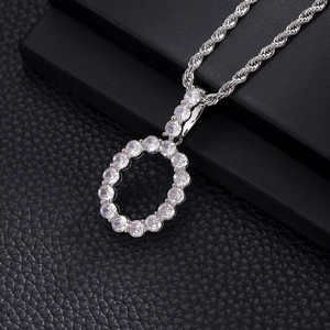 Macro view of silver round zircon pendant with intricate hollow design on rope chain
