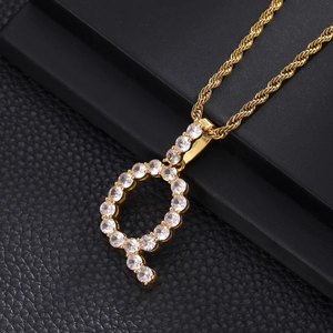 Detail view of gold hip hop letter P pendant with zircon stones and rope chain