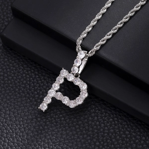 Close-up of letter P pendant with white zircon stones on a silver rope chain necklace