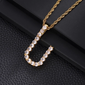 Close-up of hip-hop letter U pendant in gold finish with sparkling cubic zirconia stones
