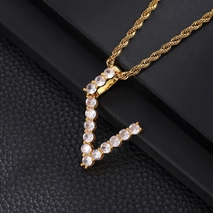 Close-up of gold V letter pendant with cubic zirconia on a classic rope chain