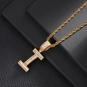 Macro detail of iced-out gold letter I pendant with sparkling cubic zirconia stones