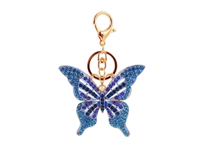 Vue détaillée du porte-clés papillon avec strass bleus et violets sur métal doré brillant
