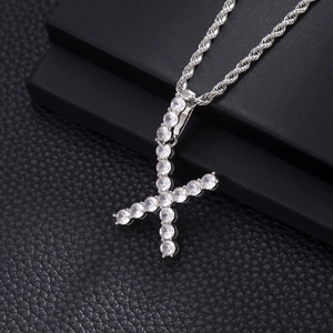 Macro shot of silver letter F pendant with pave-set cubic zirconia on a rope chain