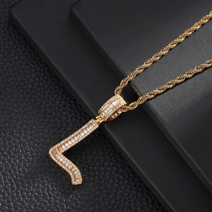 Detailed close-up of golden letter L pendant with baguette-cut micro-paved zircons