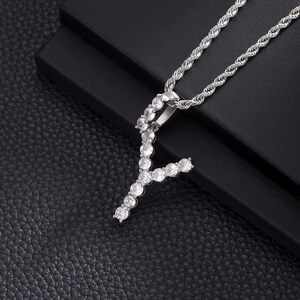 Detailed macro view of an iced out letter Y pendant necklace with rope chain and zircons