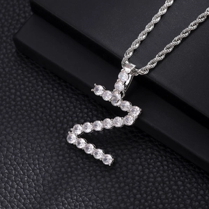 Macro shot of silver hip hop letter S pendant with zircon inlay and rope chain