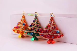 Close-up of rhinestone Christmas tree keychains in red, green and gold colors