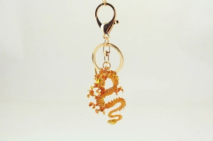 Macro detail of golden dragon keychain with intricate scales and metallic finish