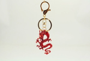 Detailed view of red Chinese dragon keychain with gold alloy lobster clasp and ring