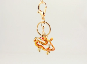 Detailed close-up of golden Chinese dragon keychain with colorful enamel work