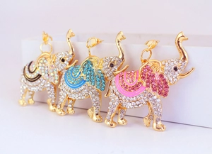 Detailed macro view of crystal rhinestone elephant charms in black, blue, and red colors