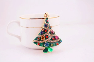 Close-up of sparkling rhinestone Christmas tree pendant with colorful crystals and gold ring