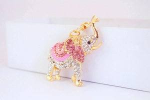 Macro detail of elephant keychain showing pink enamel waves and sparkling crystal rhinestones