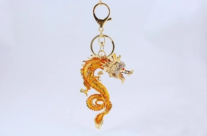 Detail of golden dragon keychain with sparkling rhinestones and lobster clasp