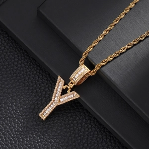Macro shot of hip-hop letter Y pendant necklace with cubic zirconia and gold rope chain