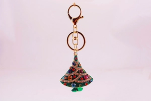 Close-up of sparkling rhinestone Christmas tree keychain with colorful crystals and gold clasp