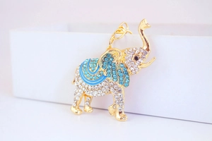 Detailed macro view of rhinestone elephant keychain with blue enamel and gold finish