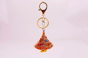 Close-up of golden Christmas tree keychain with colorful rhinestones and lobster clasp