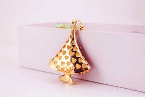Detailed close-up of golden rhinestone Christmas tree keychain with heart hollow design