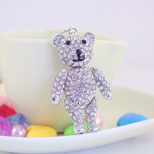 Sparkling crystal bear keychain accessory featuring white rhinestones on a white ceramic cup