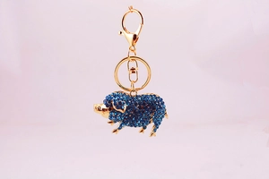 Détail du porte-clés cochon doré du zodiaque serti de strass en cristal bleu brillant